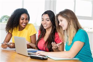 Female students using a laptop over the summer 